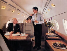 Business-class service inside a Gulfstream G200 jet with passengers and crew.