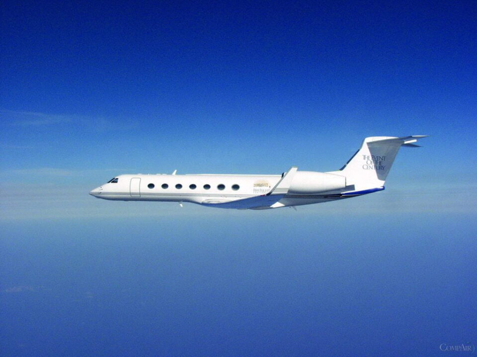 Gulfstream business jet flying at high altitude over clear blue sky
