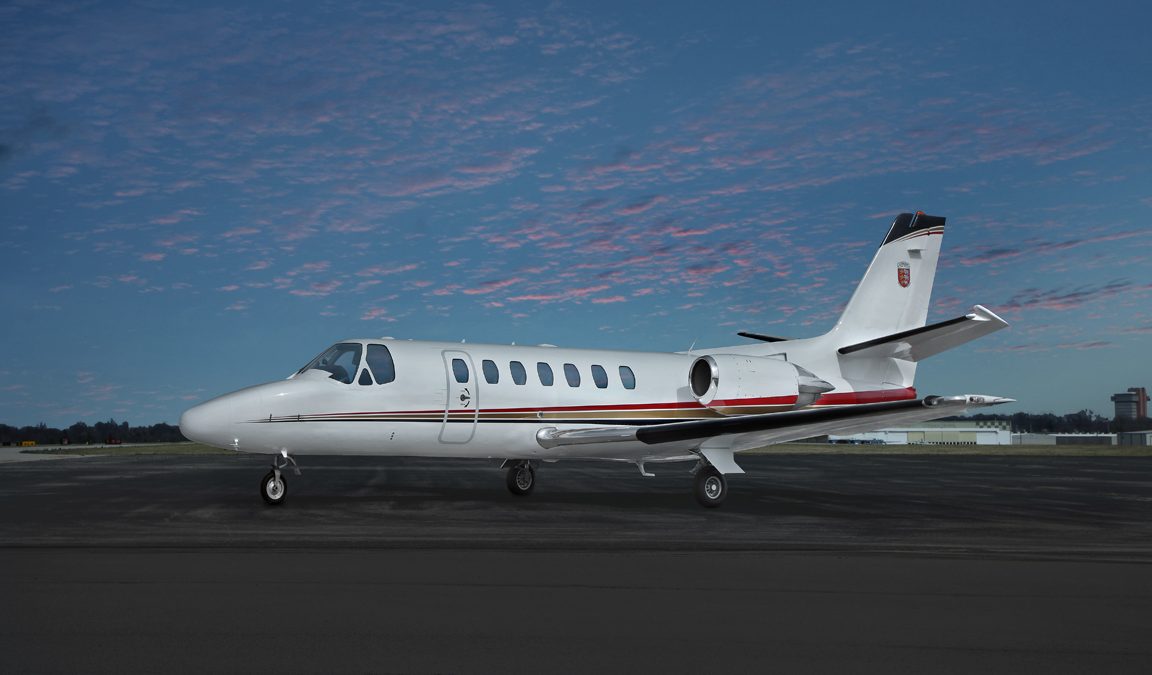 Cessna Citation Ultra light jet parked on tarmac during sunrise