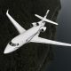 Dassault Falcon 7X private jet in flight over a river and forested terrain, viewed from above