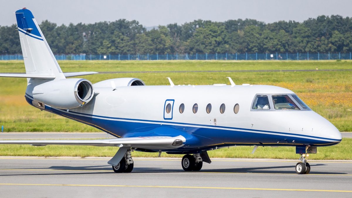 Gulfstream G150 private jet taxiing on a runway at an airport.