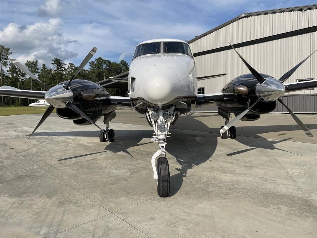 Front view of King Air A100 parked on concrete ramp