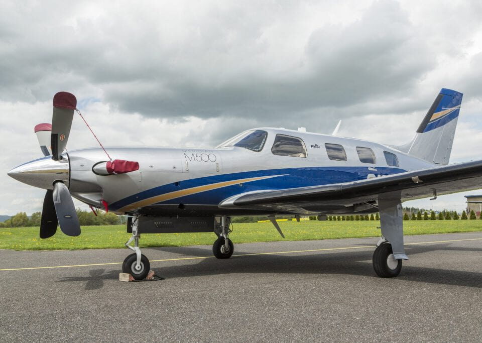 Piper M500 turboprop parked on ramp with propeller covers