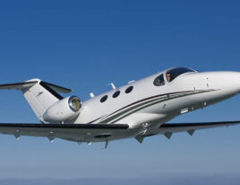 Cessna Citation Mustang light jet flying against a clear blue sky. 5