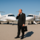 Businessman deciding between two private jets on the tarmac