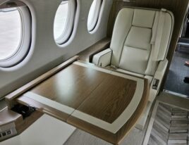 Falcon 2000 crew seat in brown leather beside cockpit