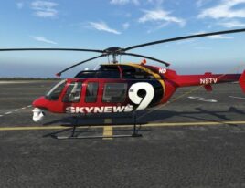 Side view of SkyNews 1999 Bell 407 helicopter on runway with full rotor extension
