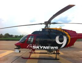 1999 Bell 407 helicopter with SkyNews 9 livery parked on ramp with nose camera