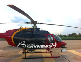 1999 Bell 407 helicopter parked on ramp with HD broadcast camera b. Image Caption:
