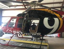 1999 Bell 407 helicopter parked in hangar with door open
