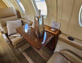 Citation III club seating with fold-out wood table and champagne setup
