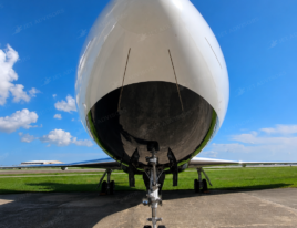 Front nose view of a 2002 Dassault Falcon 2000 business jet parked on an airport ramp.