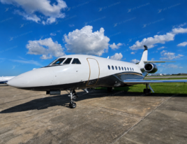 2002 Dassault Falcon 2000 business jet shown from a front three-quarter view on an airport ramp.
