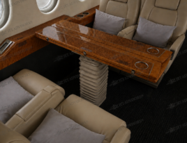 2002 Dassault Falcon 2000 cabin conference and dining area with cream leather seating and wood veneer table.